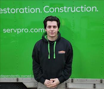 photo of Shawn standing in front a green SERVPRO box truck
