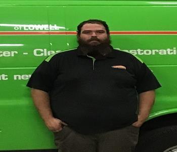 photo of George standing in front a SERVPRO green truck