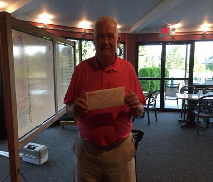 photo closest to the pin winner holding his tickets