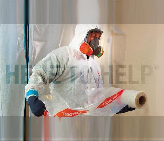 a SERVPRO employee in PPE prepping an area for cleaning