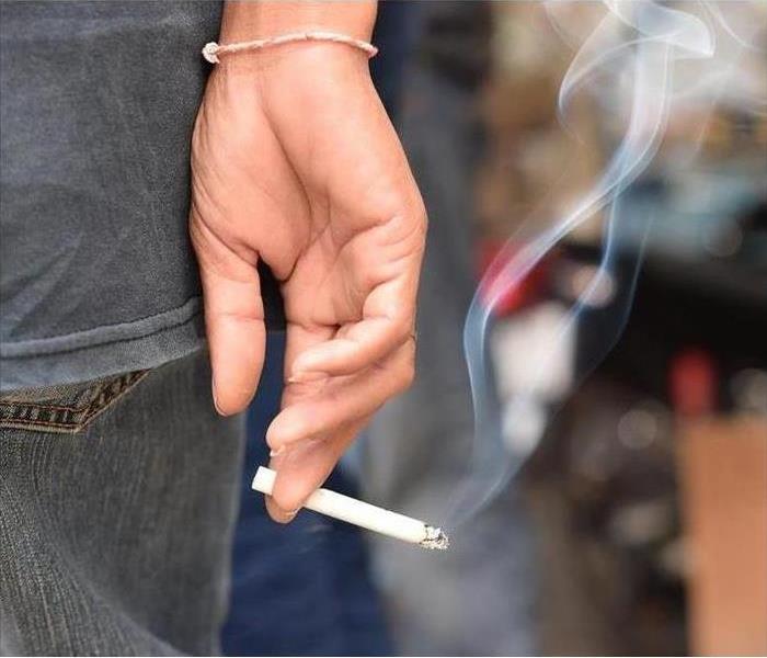 A smoking cigarette in someones hand